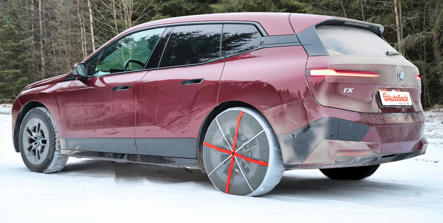 Vue arrière des chaînes à neige textiles AutoSock montées sur les roues arrière du BMW SUV iX